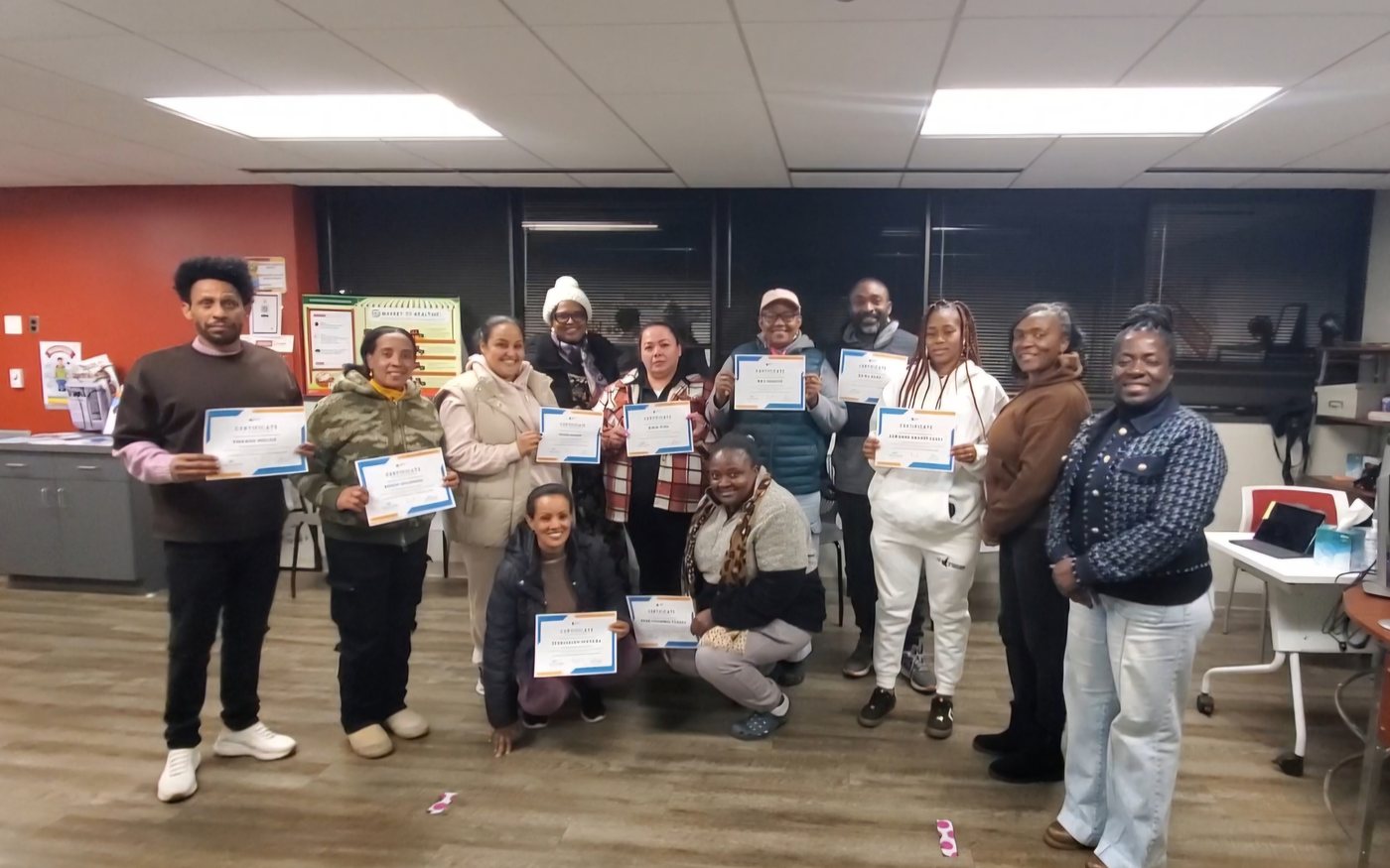 An English class celebrating with their certificates